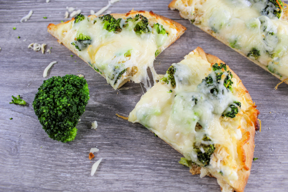 slices of chicken and broccoli flatbread pizza