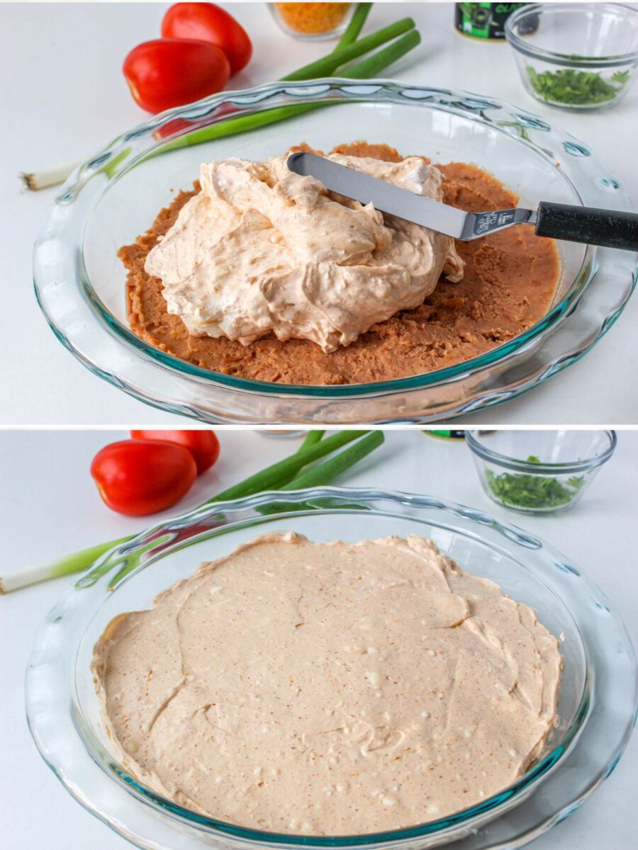 The seasoned cream cheese mixture spread evenly over the refried bean layer before adding the shredded cheese.