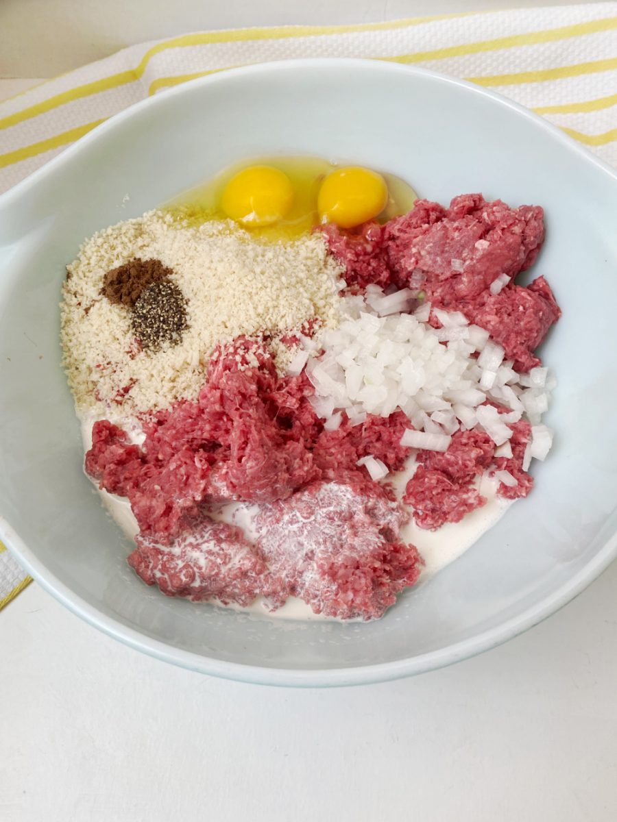 large bowl with ground beef and other ingredients for Swedish meatballs