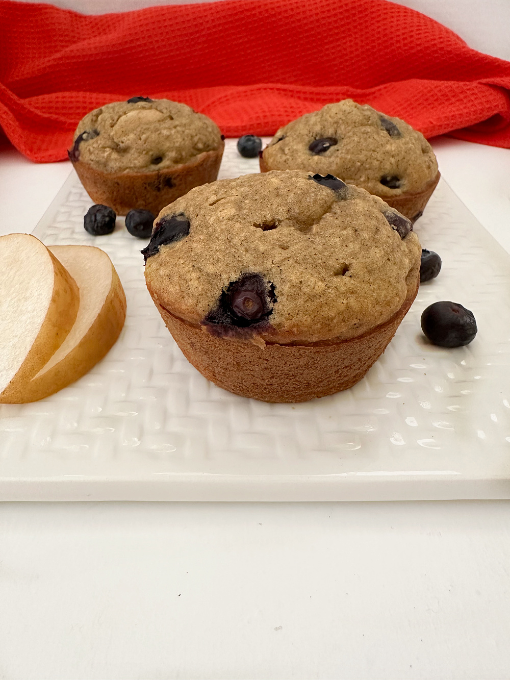blueberry pear muffins with allspice on white platter ready to enjoy