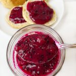 close up dragon fruit jam in mason jar with spoon