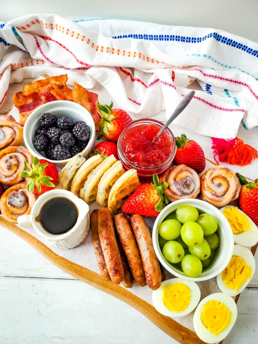 breakfast board with waffles, fruit, meat and more