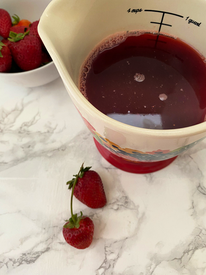 strawberry syrup cooling in measuring glass