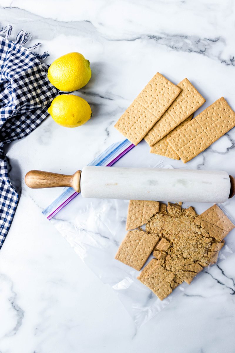 crushing graham crackers with a rolling pin