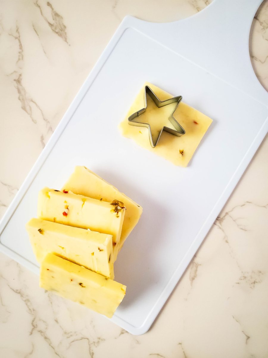 cutting stars shapes out of pepper jack cheese