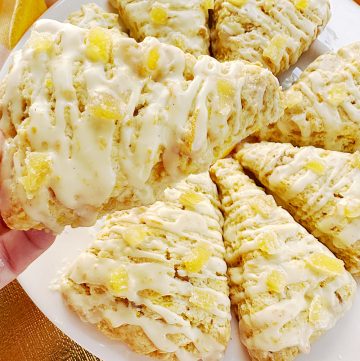 holding a glazed Candied Ginger Orange Scones
