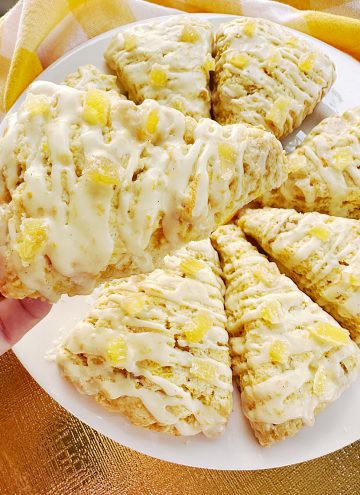holding a glazed Candied Ginger Orange Scones
