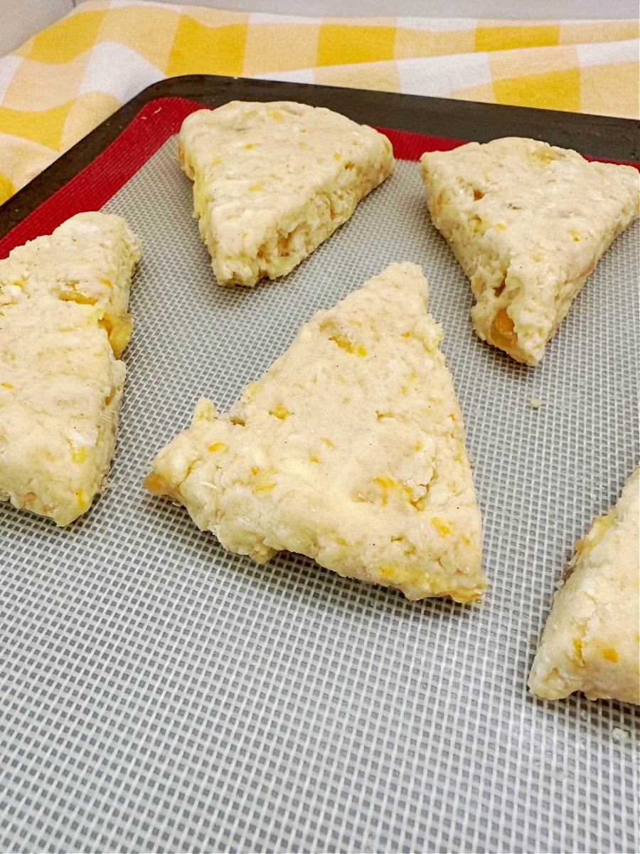 orange ginger scones cut and ready to bake on baking sheet