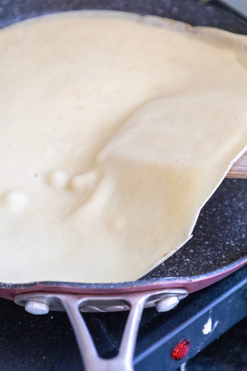 crepe ready to flip in skillet when top has bubbles