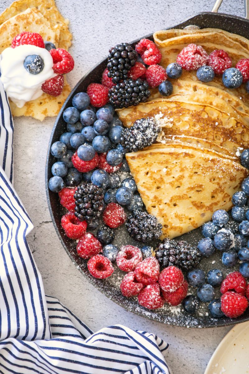fresh berries featuring homemade crepes in large serving skillet