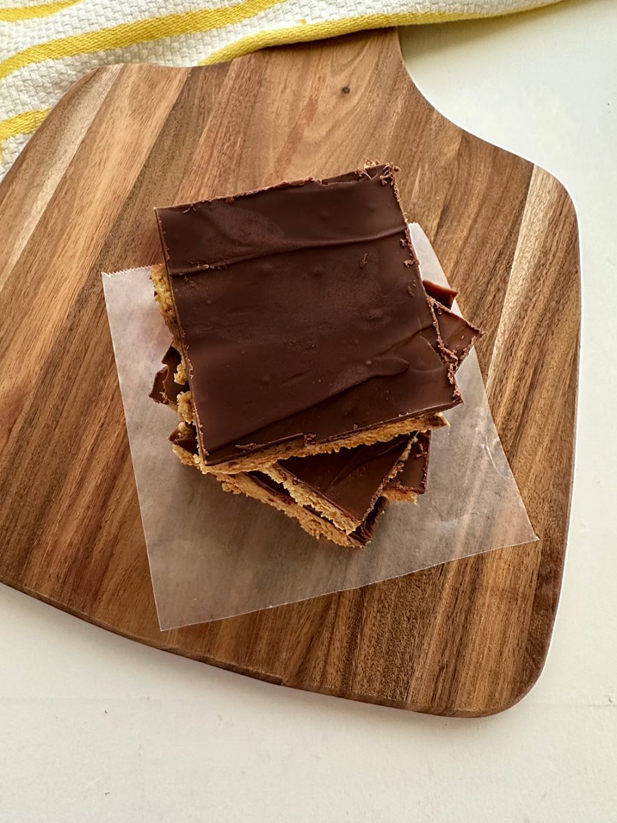 overhead view of peanut butter bars with chocolate served on wooden board