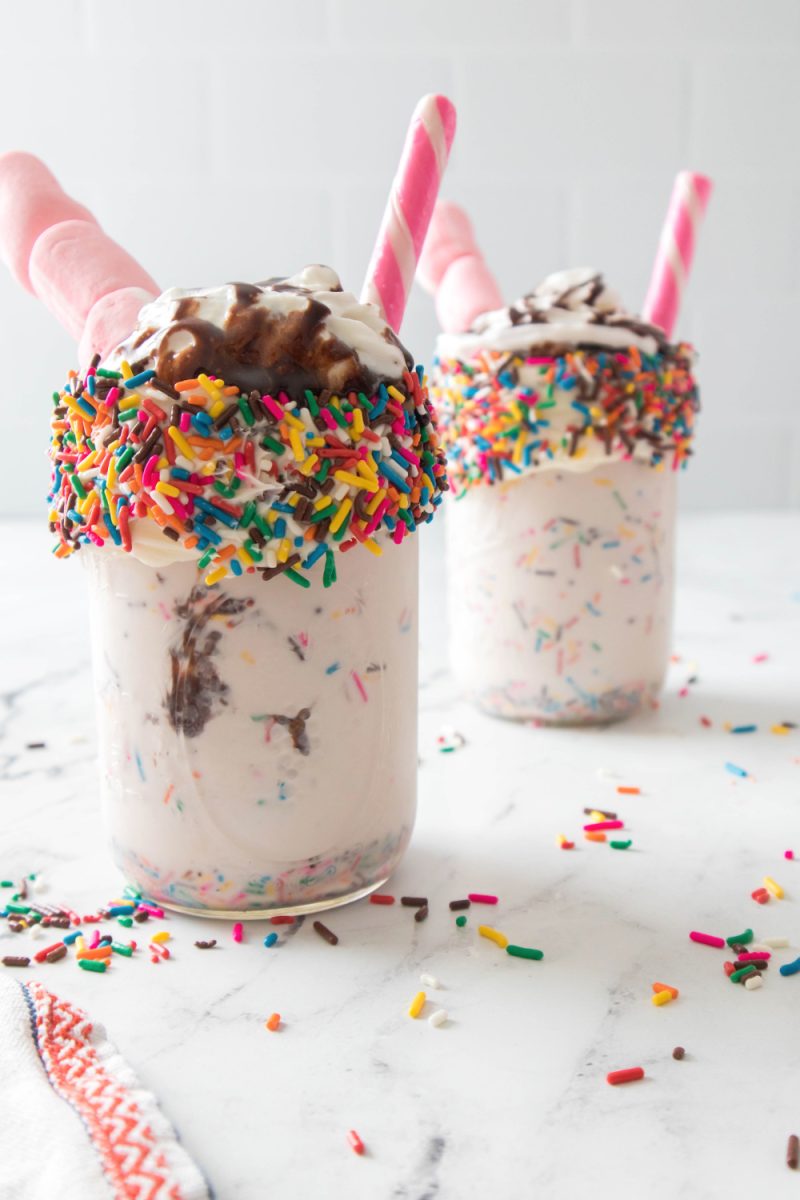 two vanilla bean funfetti milkshakes in glasses