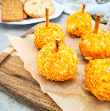Mini Pumpkin Cheese Balls close up on wooden tray