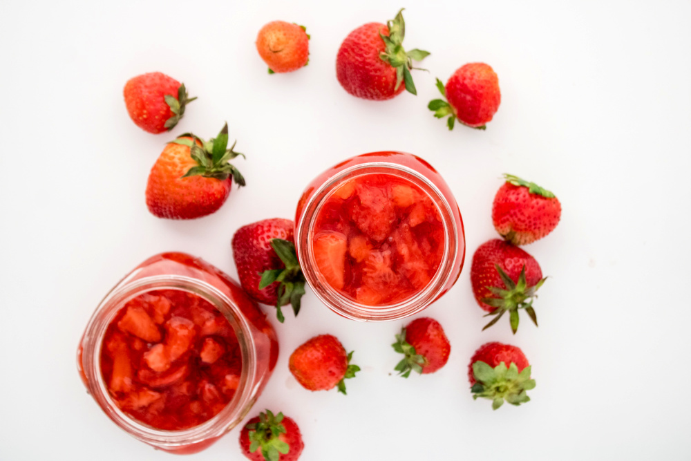 overhead view of strawberry preserves in mason jars