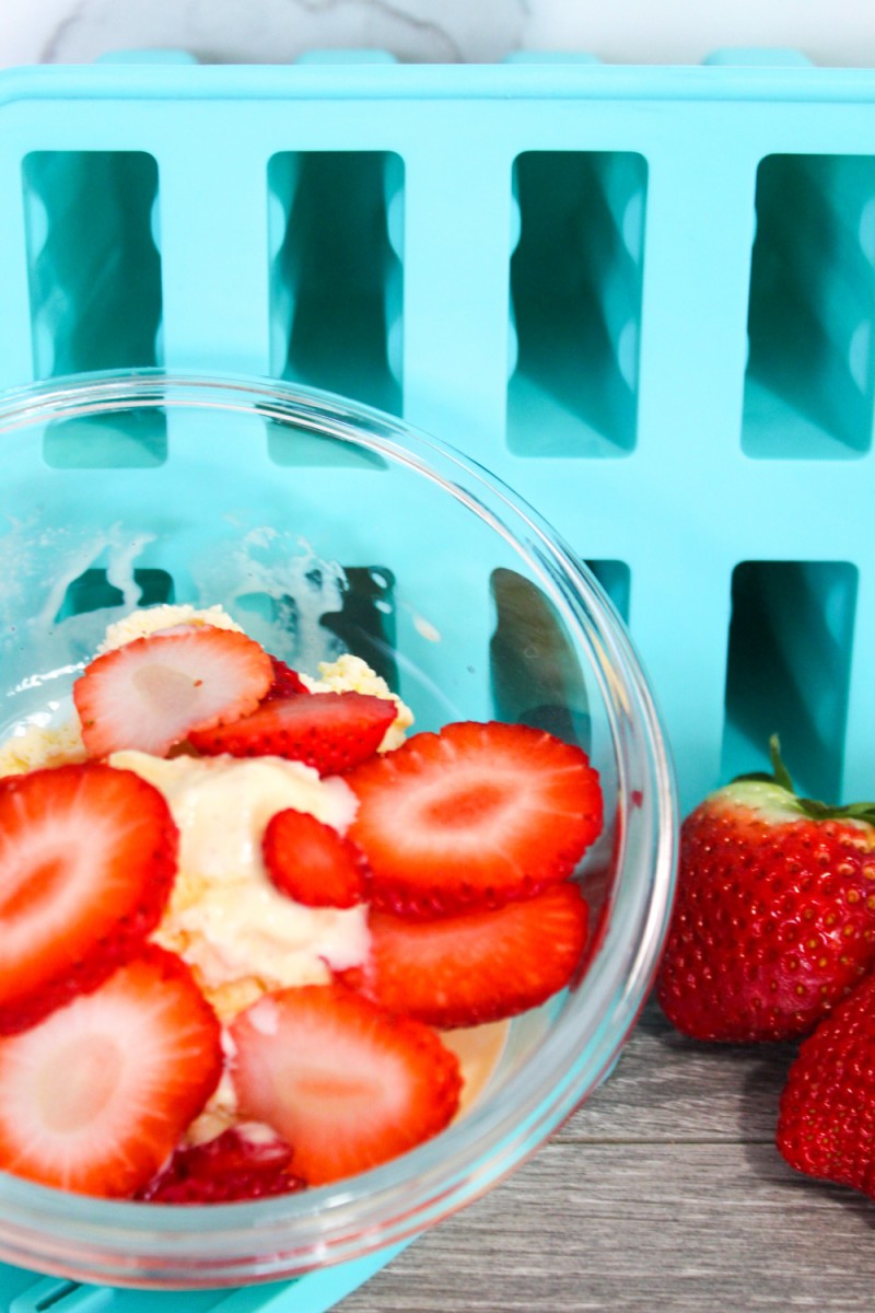 sliced strawberries wih ice cream in bowl
