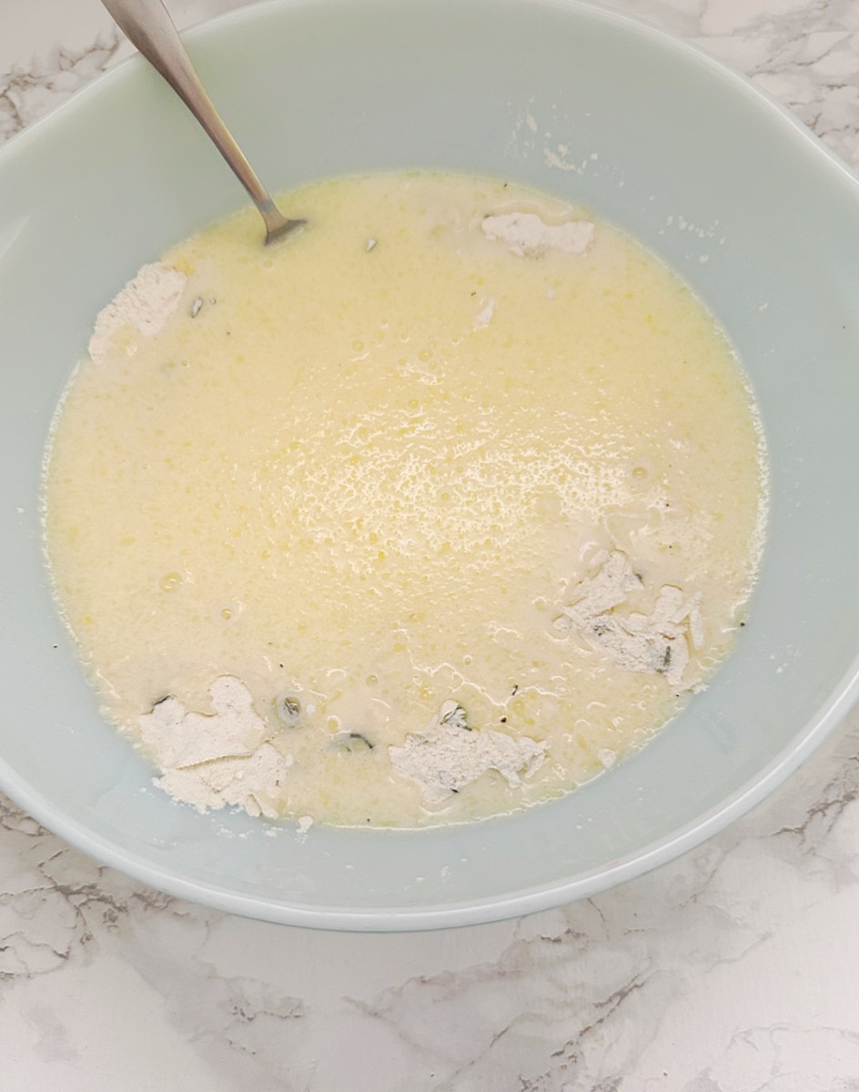 adding wet ingredients to flour mixture in bowl