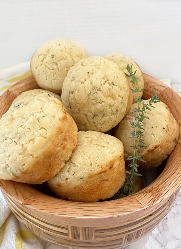 bowl of cheese and herb muffins with thyme sprigs