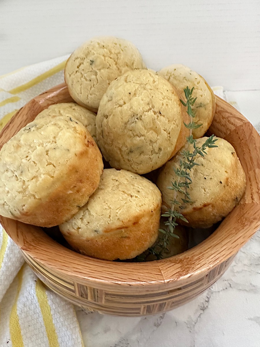 cheese and herb muffins in wooden bowl