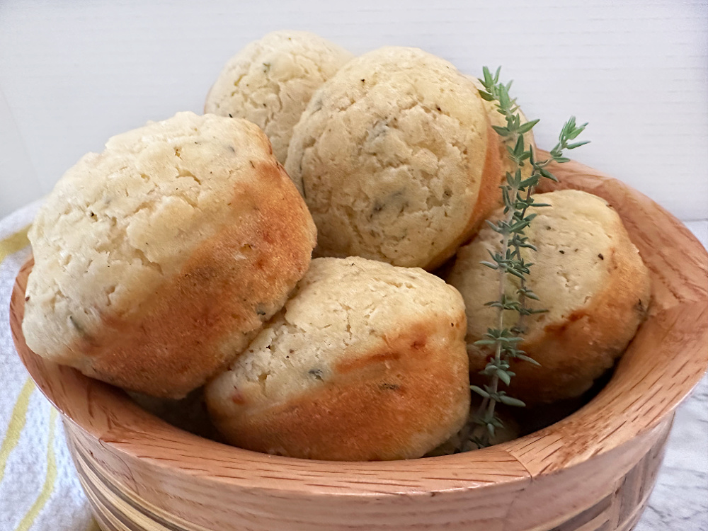 cheesy herb muffins in handmade bowl
