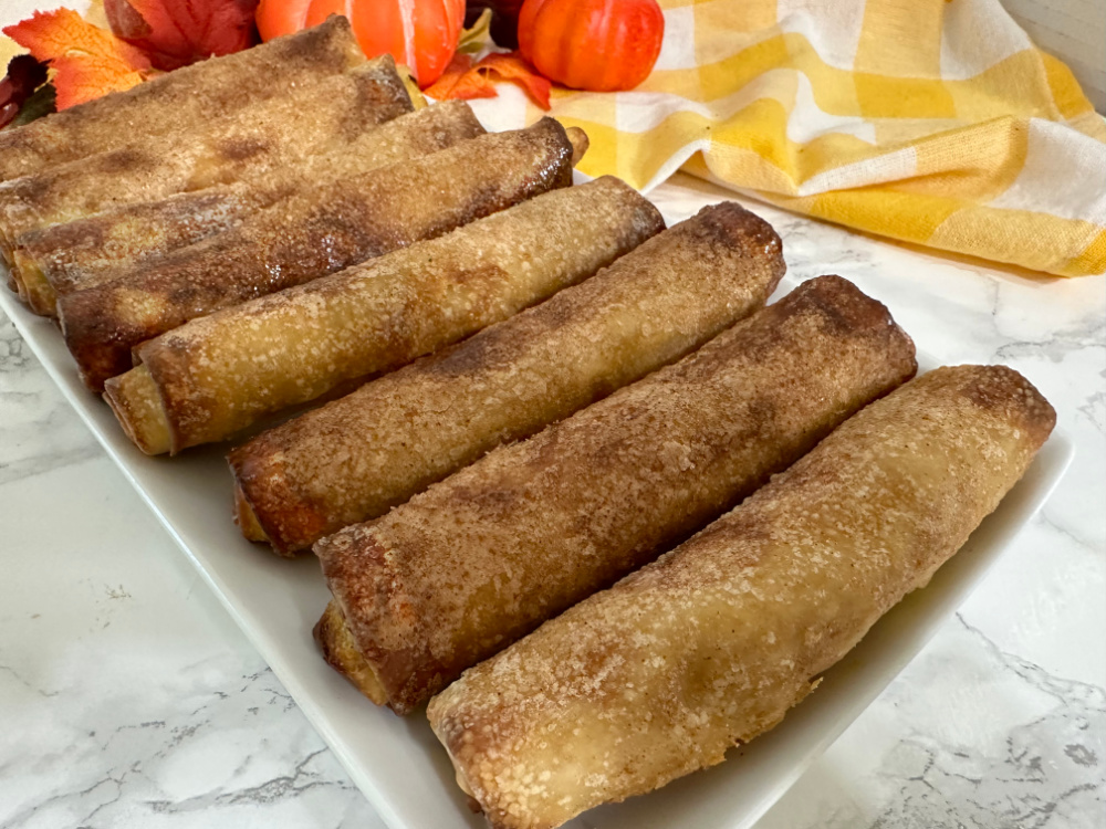 close up of air fryer egg rolls with pumkpin cheesecake filling