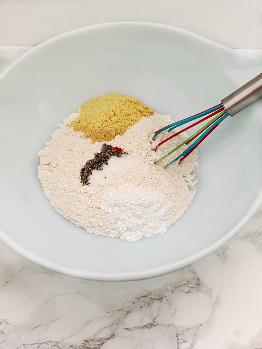 dry ingredients in large white bowl with whisk