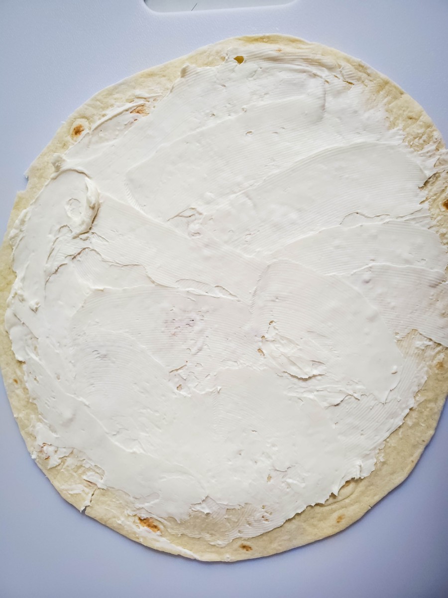 spread cream cheese mixture on to large flour tortilla shell