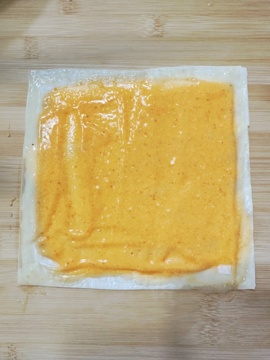 spread filling out and brush melted butter on edges of wrapper - 1