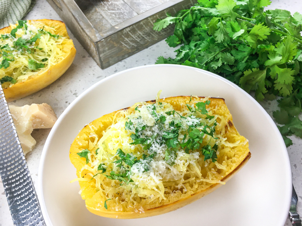 roasted spaghetti squash with Parmesan on white plate