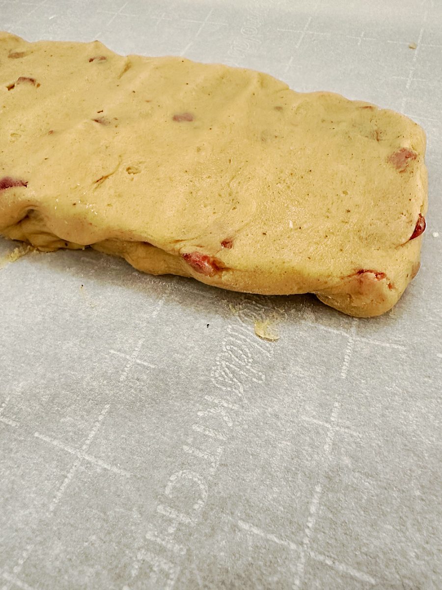 close up of fruitcake biscotti dough on baking sheet