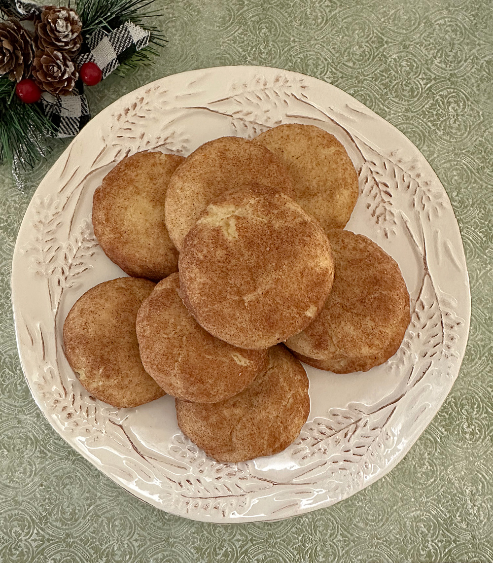orange cardamom snickerdoodle cookies on white festive plate