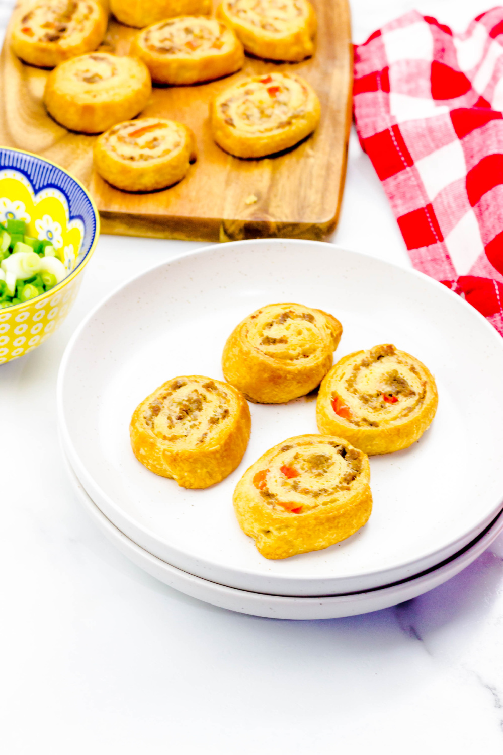 sausage cream cheese crescent rolls on white platter