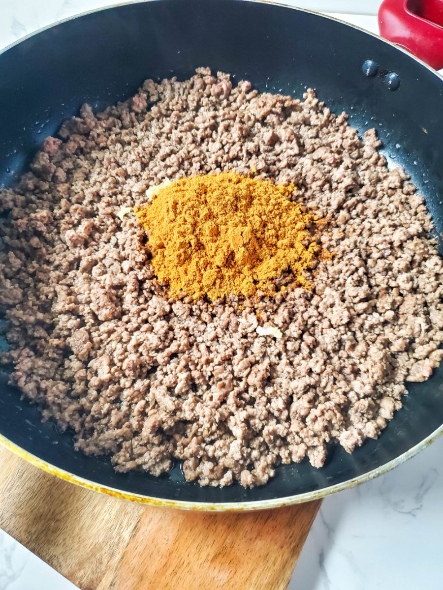 brown ground beef add garlic and taco seasoning