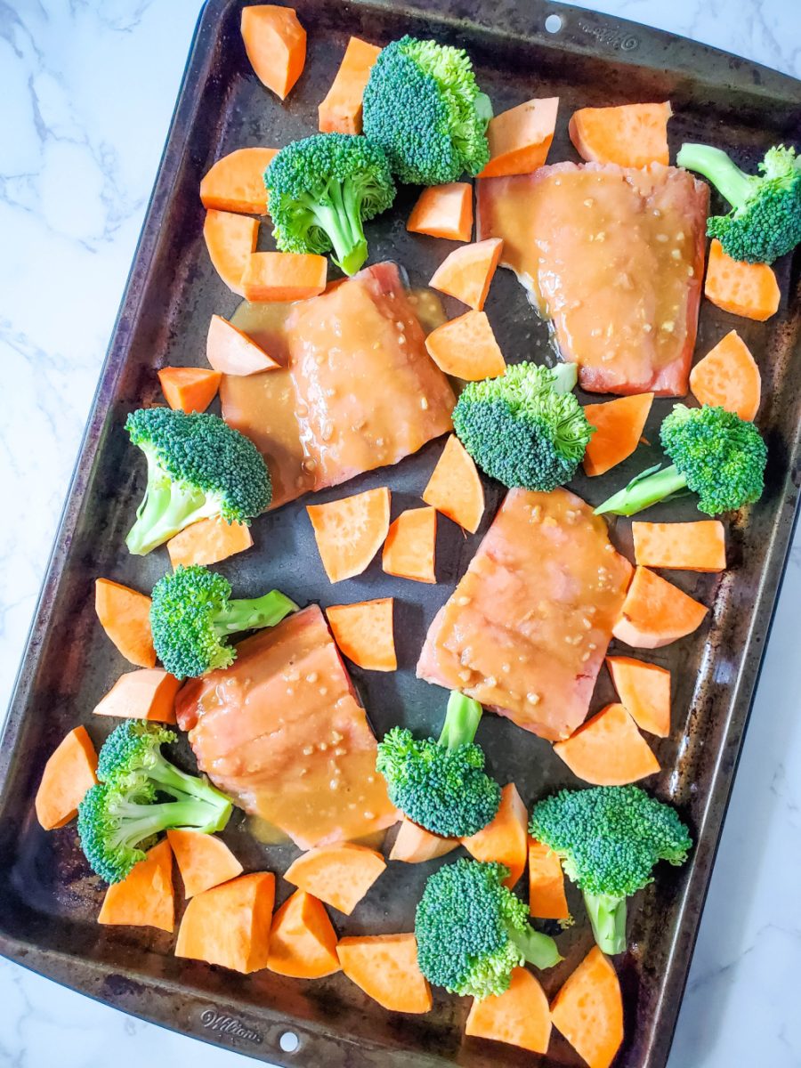 add the vegetables around the salmon on pan