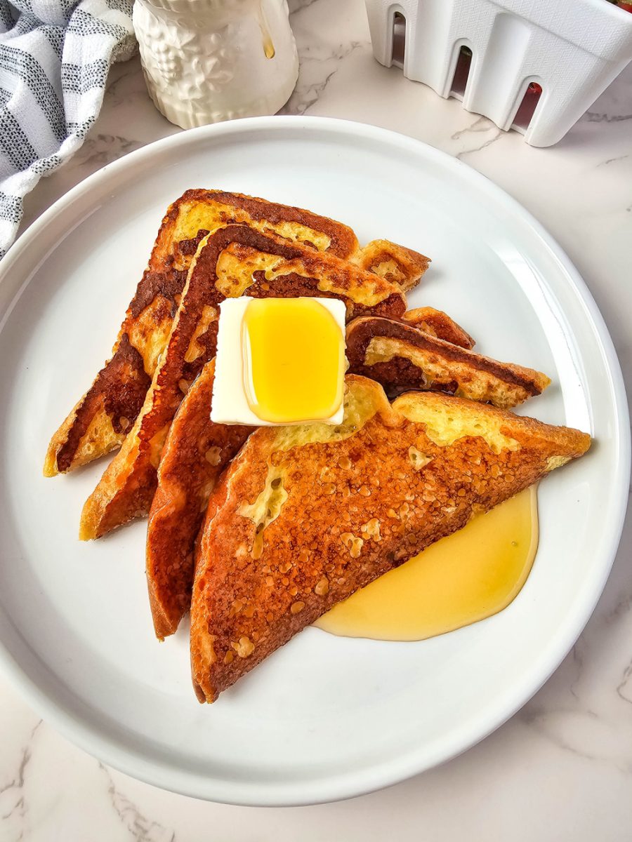 close up of French toast on white plate