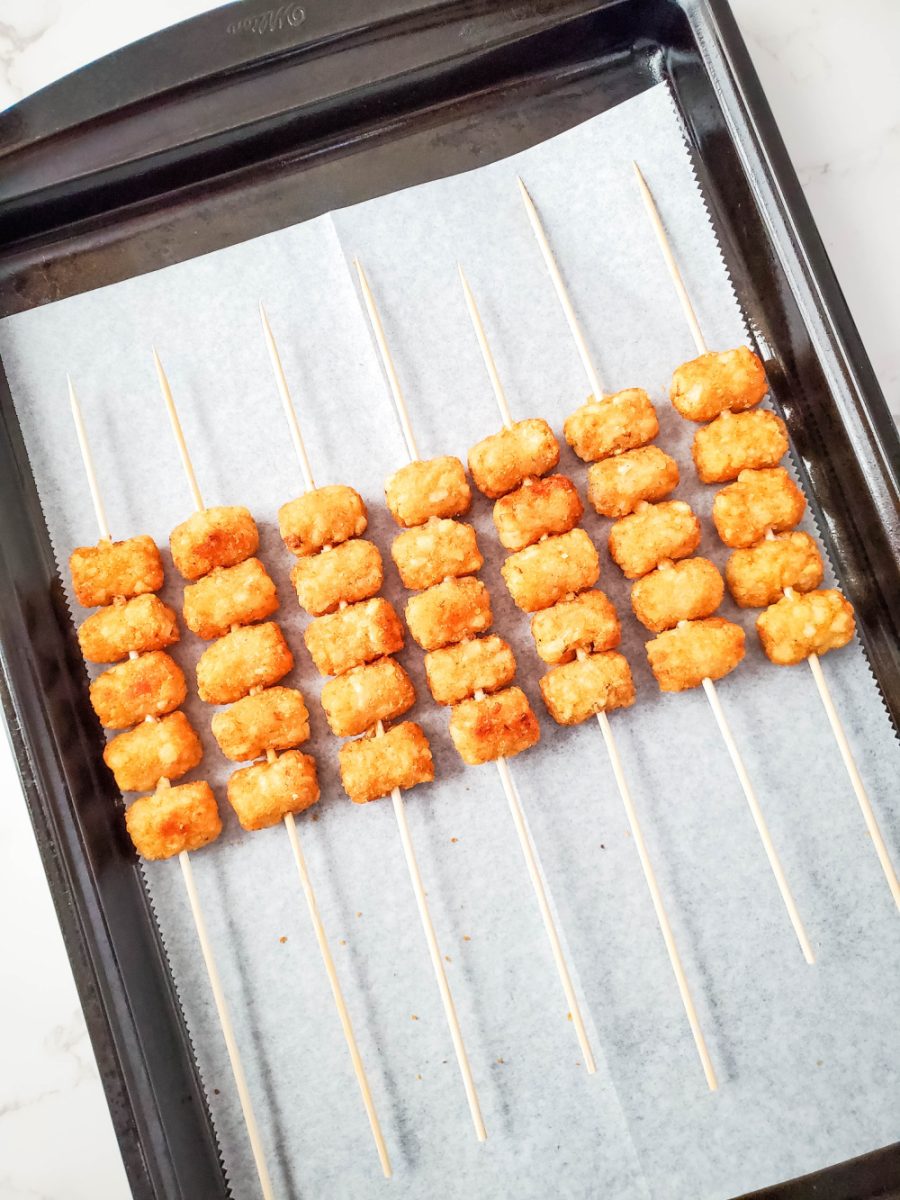 place baked tots on to wooden skewers