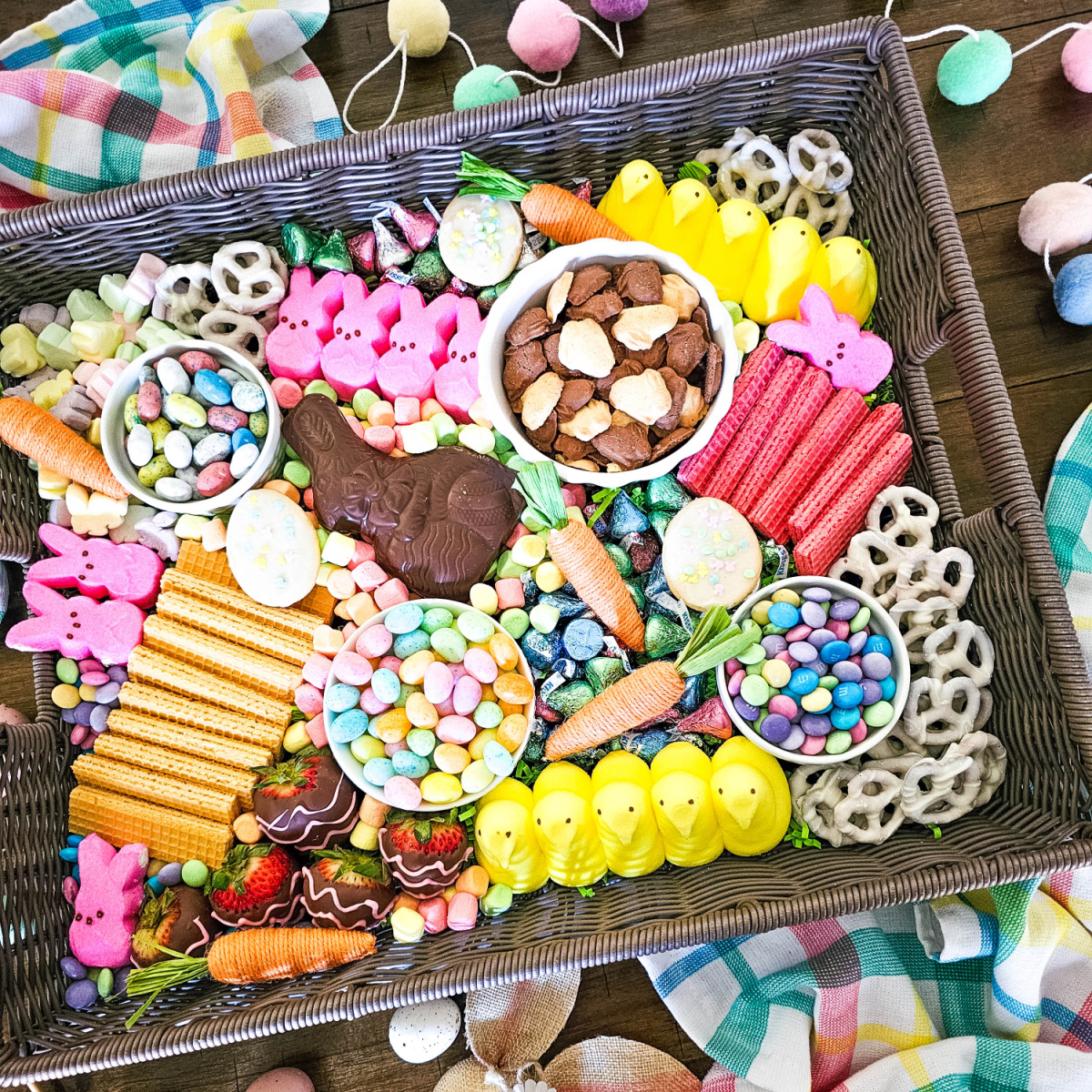feature image for the Easter Candy Charcuterie board.. Seasonal themed candy in a brown wicker tray.