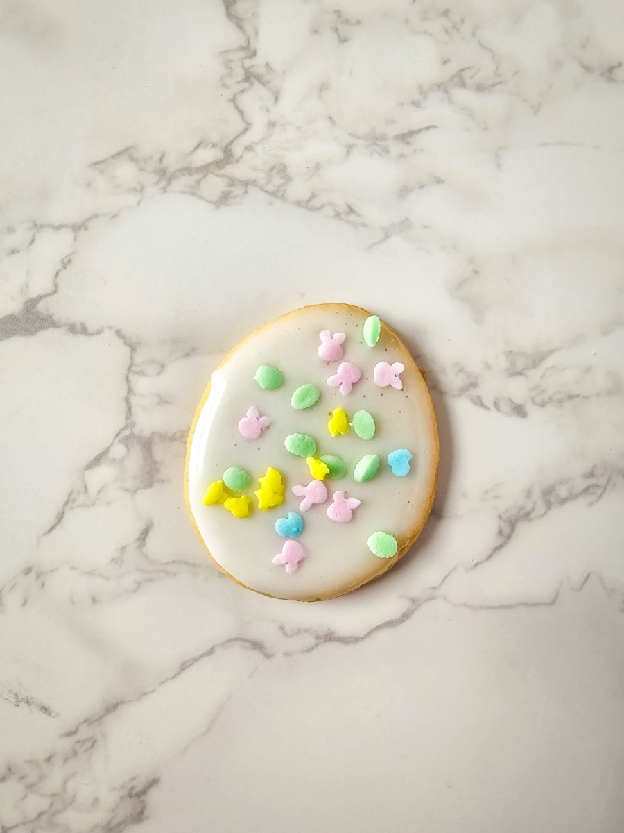 finish decorating cookie by adding sprinkles