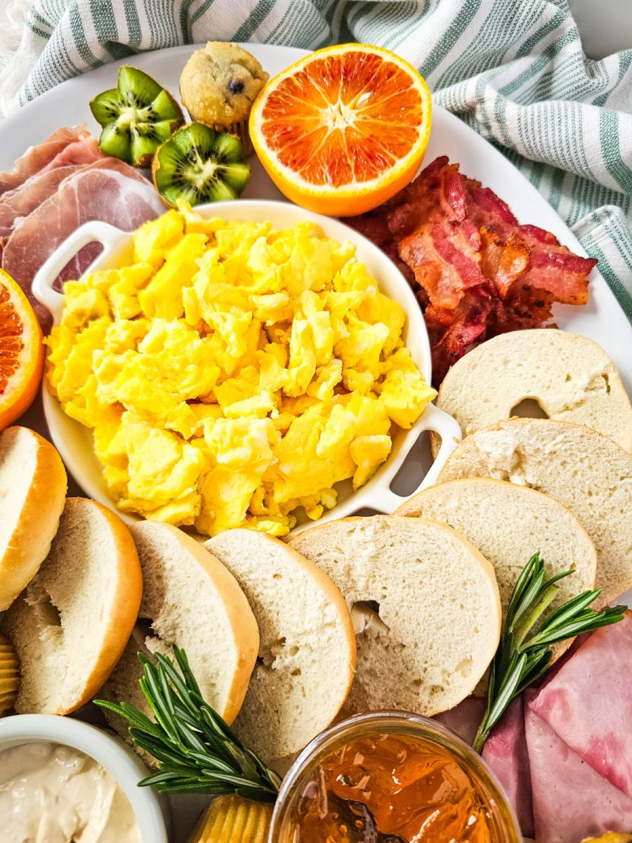 mini bagels and eggs with fruit close up of charcuterie board
