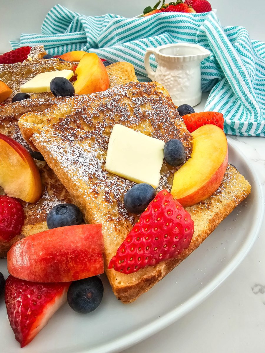 close up of texas toast french toast with fruit on plate