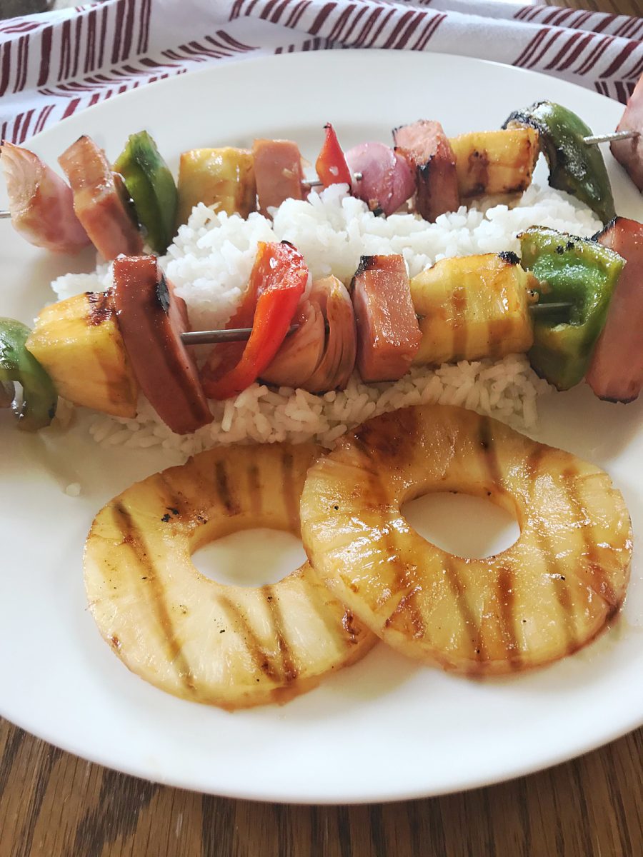 grilled ham and pineapple kabobs on white plate