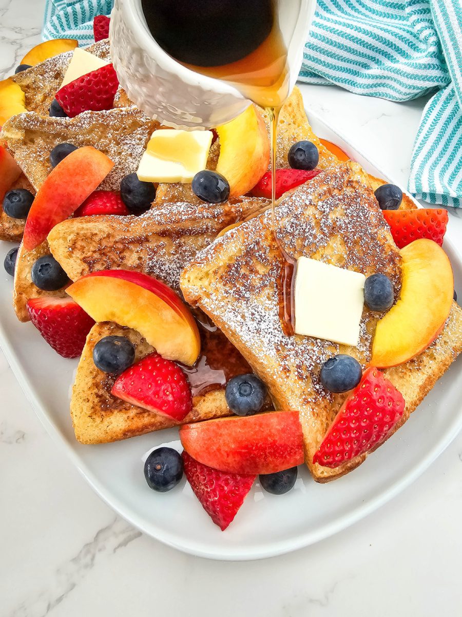 pour syrup over texas toast french toast and fruit