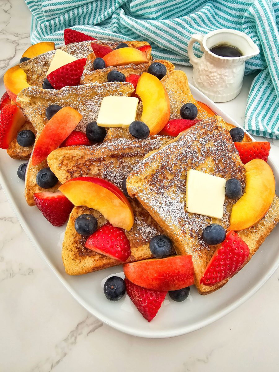 texas toast French toast with fresh fruit slices on platter