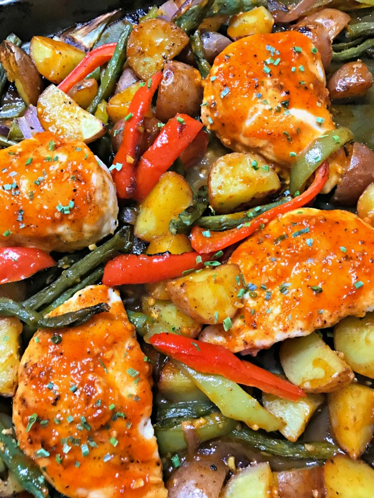 baking sheet with a spicy sweet chicken dinner 