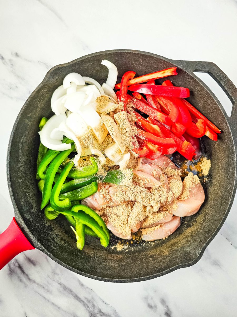 add chicken and vegetables with seasoning in skillet