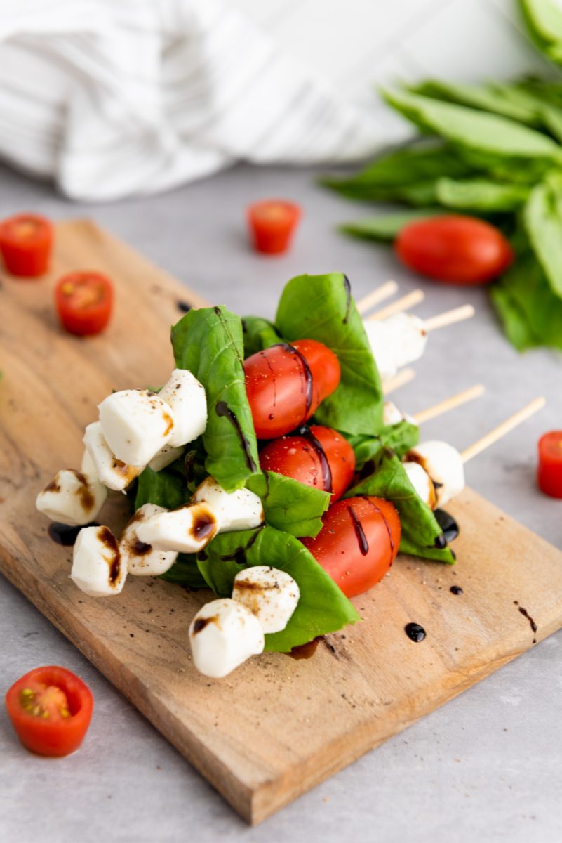 caprese skewers stacked on tray