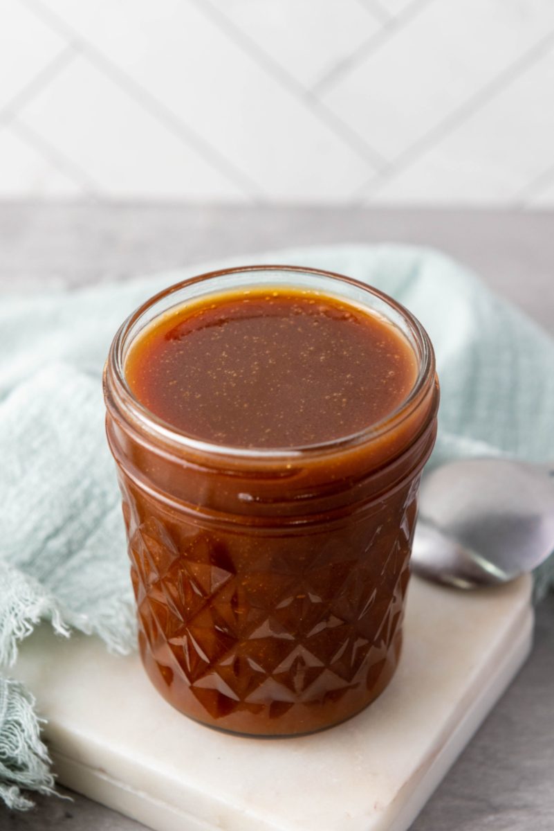 homemade caramel topping close up in jar