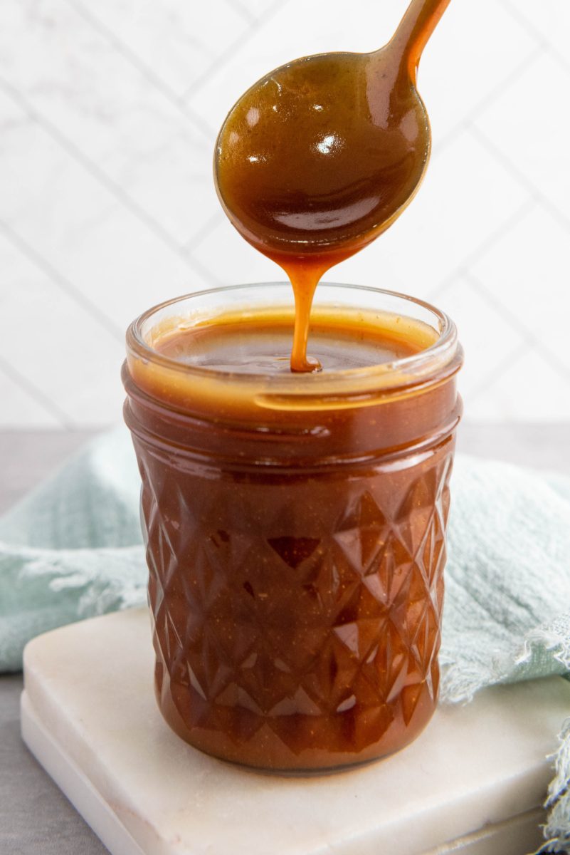 spoon drizzling caramel sauce