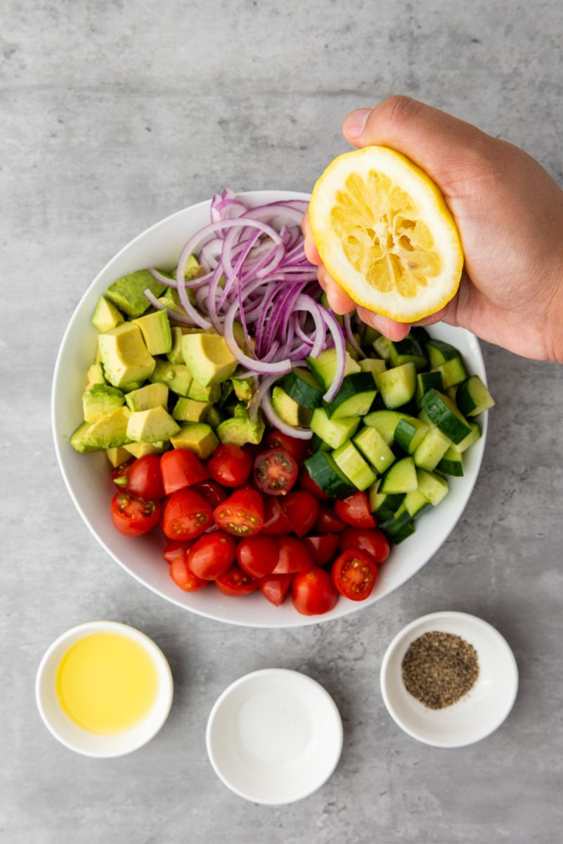 add lemon juice and oil to salad bowl