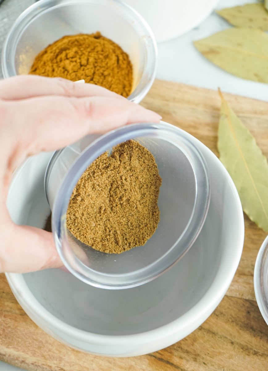 adding spices to bowl