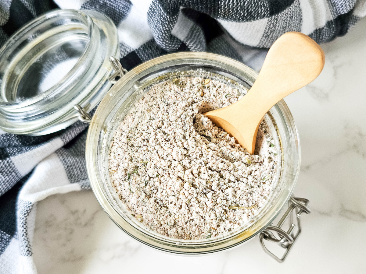 beef seasoning for stew in jar with wooden spoon